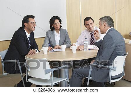 Businesspeople having meeting in office View Large Photo Image Stock Photography - Businesspeople having meeting in office. Fotosearch