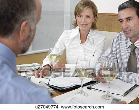 Picture - Businesspeople having meeting in restaurant. Fotosearch