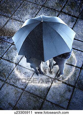Businesspeople hidden under one umbrella View Large Photo Image Stock Image - Businesspeople hidden under one umbrella. Fotosearch