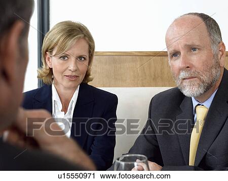 Stock Image - Businesspeople in restaurant. Fotosearch