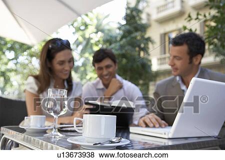 Businesspeople meeting at outdoor cafe View Large Photo Image Stock Photo - Businesspeople meeting at outdoor cafe. Fotosearch