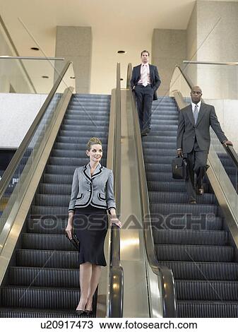 Businesspeople on escalators View Large Photo Image Stock Image - Businesspeople on escalators. Fotosearch
