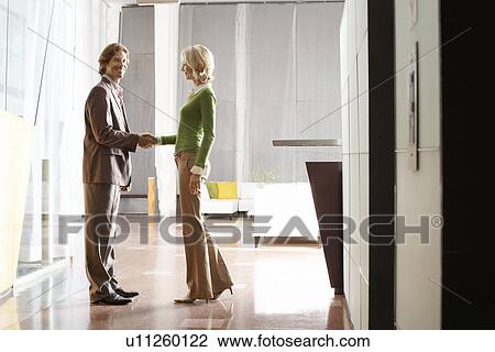 Businesspeople shaking hands, indoors View Large Photo Image Stock Image - Businesspeople shaking hands, indoors. Fotosearch
