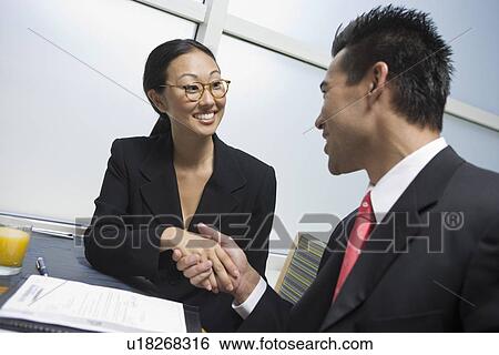 Businesswoman and businessman shaking hands View Large Photo Image Stock Photograph - Businesswoman and businessman shaking hands. Fotosearch