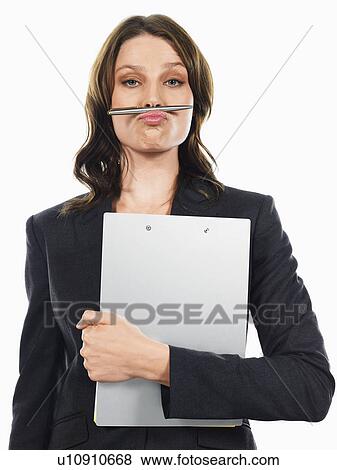 Businesswoman pulling funny face with pen View Large Photo Image Stock Photo - Businesswoman pulling funny face with pen. Fotosearch