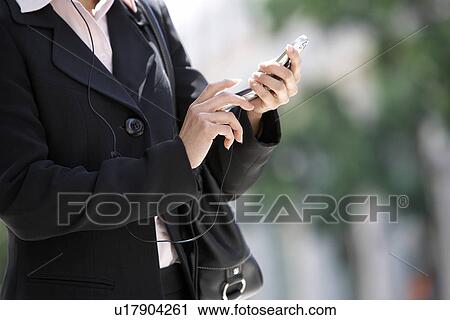 Businesswoman Using Cell Phone, mid section View Large Photo Image Stock Image - Businesswoman Using Cell Phone, mid section. Fotosearch