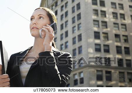 Businesswoman using mobile phone in street View Large Photo Image Stock Image - Businesswoman using mobile phone in street. Fotosearch