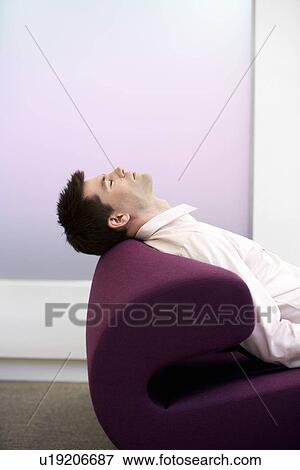 Casually dressed Businessman Sleeping on modern sofa, profile View Large Photo Image Stock Photo - Casually dressed Businessman Sleeping on modern sofa, profile. Fotosearch