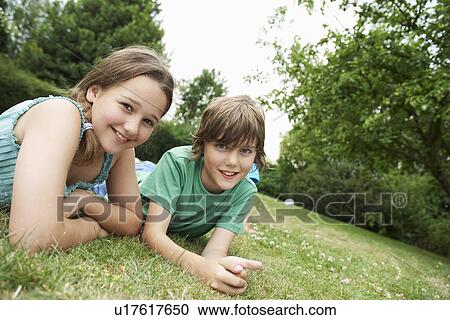 Children Lying on Meadow View Large Photo Image Stock Image - Children Lying on Meadow. Fotosearch
