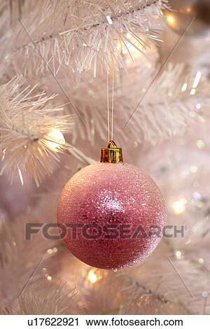 Stock Image - Christmas bauble hanging on tree, close-up. Fotosearch