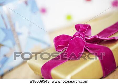 Christmas present wrapped with Velvet Bow, close up View Large Photo Image Stock Image - Christmas present wrapped with Velvet Bow, close up. Fotosearch