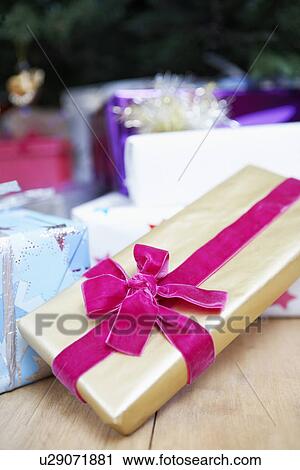 Stock Image - Christmas present wrapped with Velvet Bow, close up. Fotosearch