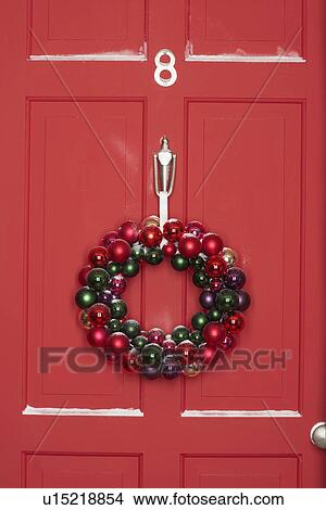 Christmas wreath hanging on door View Large Photo Image Picture - Christmas wreath hanging on door. Fotosearch