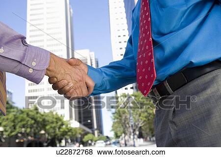 Close-up of businessmen handshake, outdoors View Large Photo Image Stock Photo - Close-up of businessmen handshake, outdoors. Fotosearch