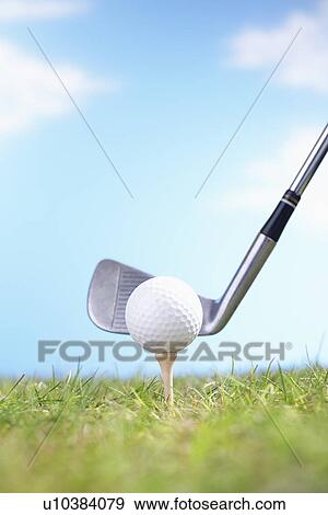 Close up of golf ball on tee with golf club View Large Photo Image Stock Photo - Close up of golf ball on tee with golf club. Fotosearch