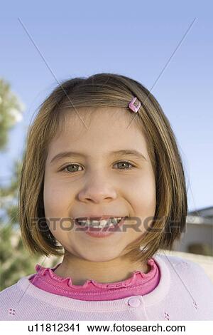 Stock Image - Close-up portrait of girl (5-6), smiling. Fotosearch