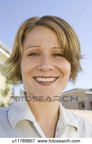 Stock Photo - Close-up portrait of mid-adult woman, smiling. Fotosearch