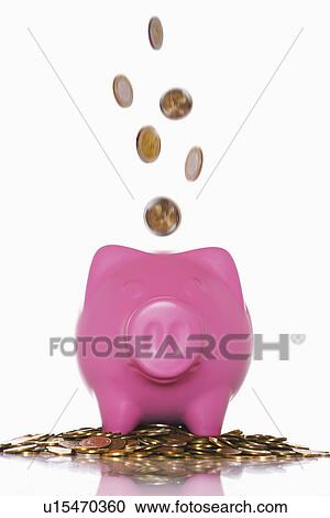 Coins pouring into overflowing piggy bank View Large Photo Image Stock Image - Coins pouring into overflowing piggy bank. Fotosearch