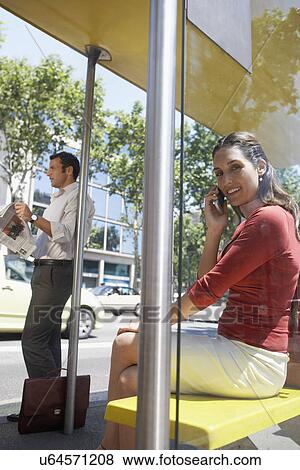 Stock Photo - Commuters Waiting at Bus Stop Shelter. Fotosearch