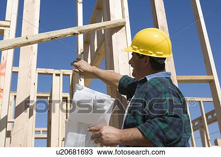 Construction worker holding blueprint, smiling View Large Photo Image Stock Image - Construction worker holding blueprint, smiling. Fotosearch