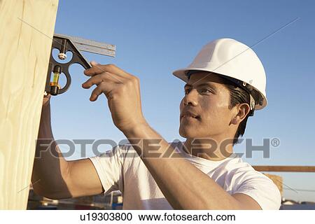 Construction Worker in Hard Hat Building House View Large Photo Image Stock Image - Construction Worker in Hard Hat Building House. Fotosearch