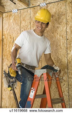 Construction worker on ladder View Large Photo Image Stock Photo - Construction worker on ladder. Fotosearch