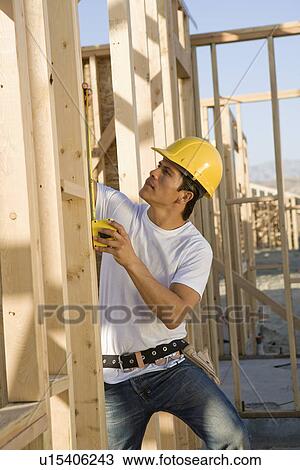 Stock Image - Construction worker on scaffoldings. Fotosearch