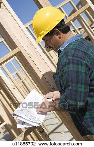 Construction Worker reading blueprint View Large Photo Image Stock Image - Construction Worker reading blueprint. Fotosearch