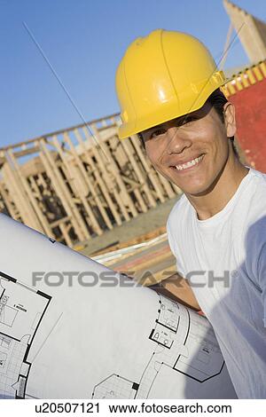 Stock Image - Construction worker smiling. Fotosearch
