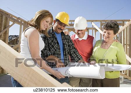 Construction workers observing plans on construction site View Large Photo Image Stock Photography - Construction workers observing plans on construction site. Fotosearch