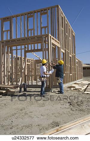 Construction workers on building site View Large Photo Image Stock Photo - Construction workers on building site. Fotosearch