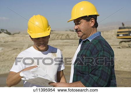 Construction Workers reading blueprint View Large Photo Image Picture - Construction Workers reading blueprint. Fotosearch