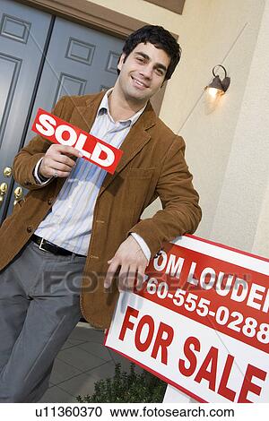 Contented estate agent outside newly sold house View Large Photo Image Stock Image - Contented estate agent outside newly sold house. Fotosearch