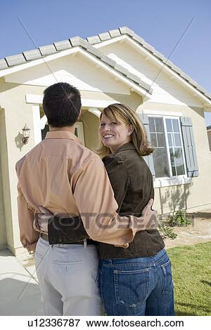 Couple admiring new house View Large Photo Image Stock Photo - Couple admiring new house. Fotosearch