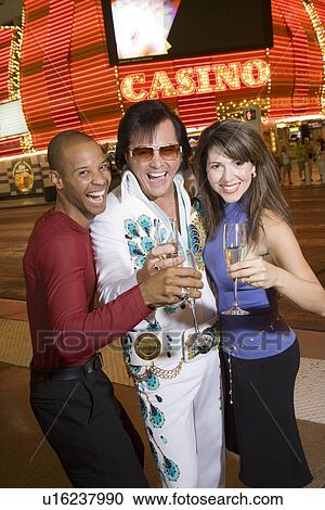 Couple and Elvis impersonator having fun View Large Photo Image Stock Image - Couple and Elvis impersonator having fun. Fotosearch