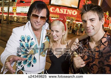 Couple and Elvis impersonator having fun View Large Photo Image Stock Photography - Couple and Elvis impersonator having fun. Fotosearch
