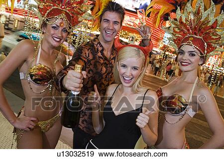 Stock Photo - Couple and female dancers having fun. Fotosearch