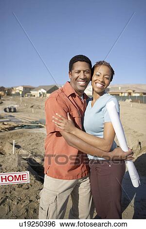 Stock Photograph - Couple by plot of land for new home. Fotosearch