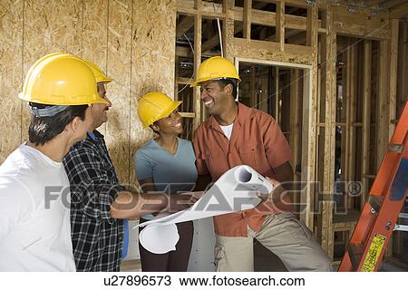Couple consulting workers on construction site View Large Photo Image Stock Image - Couple consulting workers on construction site. Fotosearch