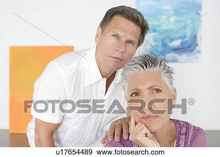Couple contemplating paintings in gallery View Large Photo Image Stock Photo - Couple contemplating paintings in gallery. Fotosearch
