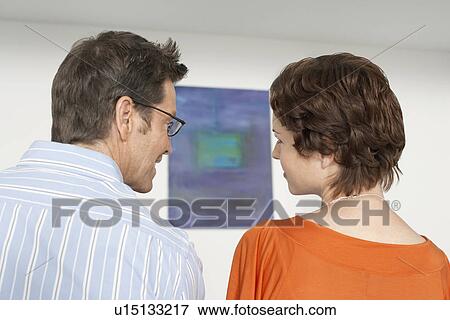 Couple discussing painting in art gallery View Large Photo Image Stock Photo - Couple discussing painting in art gallery. Fotosearch