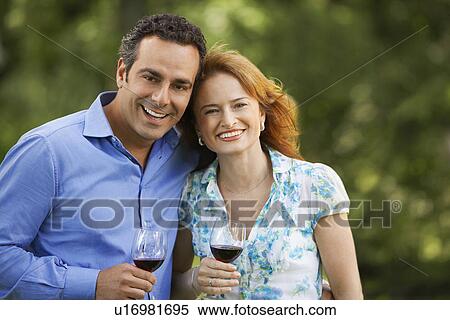 Couple Drinking Wine in back yard, portrait View Large Photo Image Stock Photography - Couple Drinking Wine in back yard, portrait. Fotosearch