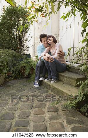 Couple embracing sitting on steps View Large Photo Image Stock Image - Couple embracing sitting on steps. Fotosearch