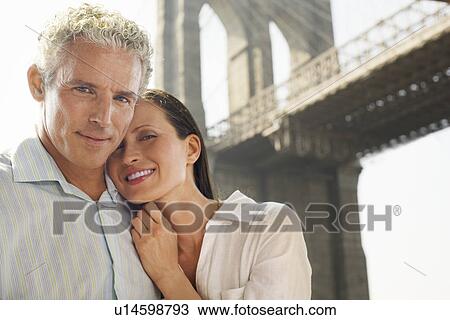 Couple embracing under Brooklyn Bridge, portrait View Large Photo Image Stock Image - Couple embracing under Brooklyn Bridge, portrait. Fotosearch