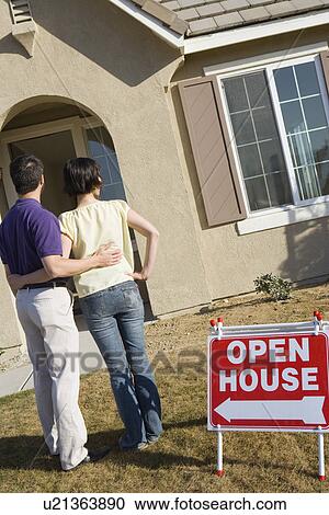 Couple examining exterior of house put on sale View Large Photo Image Stock Image - Couple examining exterior of house put on sale. Fotosearch