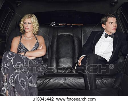 Couple in evening wear in back of car View Large Photo Image Stock Image - Couple in evening wear in back of car. Fotosearch