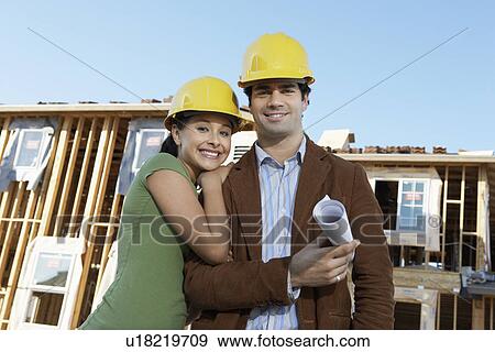 Couple in front of houses being built View Large Photo Image Stock Photo - Couple in front of houses being built. Fotosearch