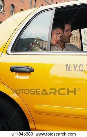 Couple in yellow taxi cab View Large Photo Image Stock Image - Couple in yellow taxi cab. Fotosearch