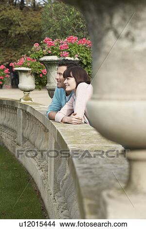 Couple looking over wall, head and shoulders View Large Photo Image Picture - Couple looking over wall, head and shoulders. Fotosearch