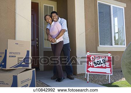 Couple moving into new house View Large Photo Image Stock Image - Couple moving into new house. Fotosearch